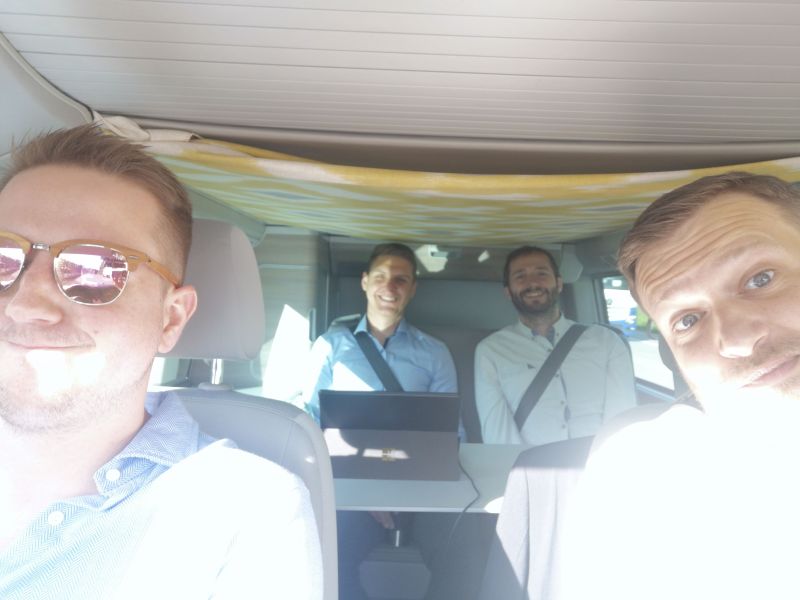 Four people in a VW bus on the way to somewhere that matters