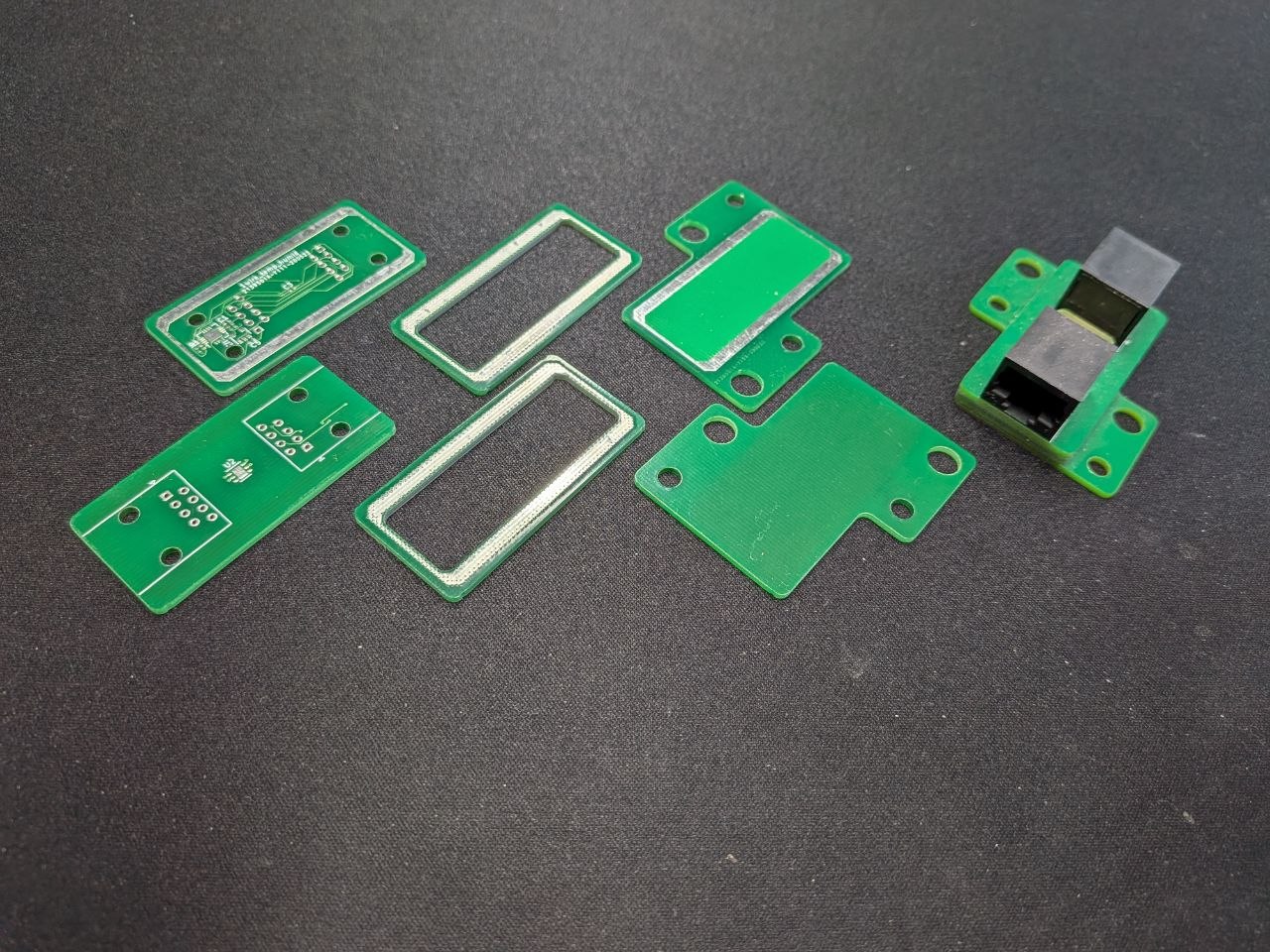 Enclosureless Cases components and assembled unit — bottom board, frame spacer, cover board, and the finished sensor