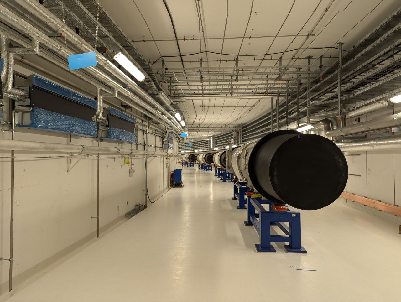 The SIS100 tunnel at FAIR, Darmstadt — superconducting dipole magnets installed, connection pipes between magnets not yet in place