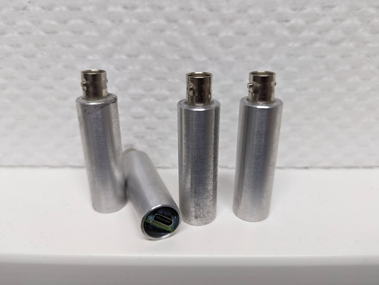Four OmnAIScope prototypes — BNC input on top, USB-C on the bottom