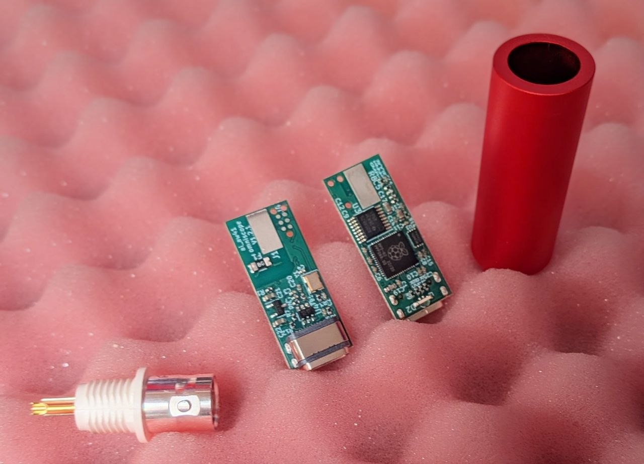 PCB, BNC connector, and housing — the three components before assembly