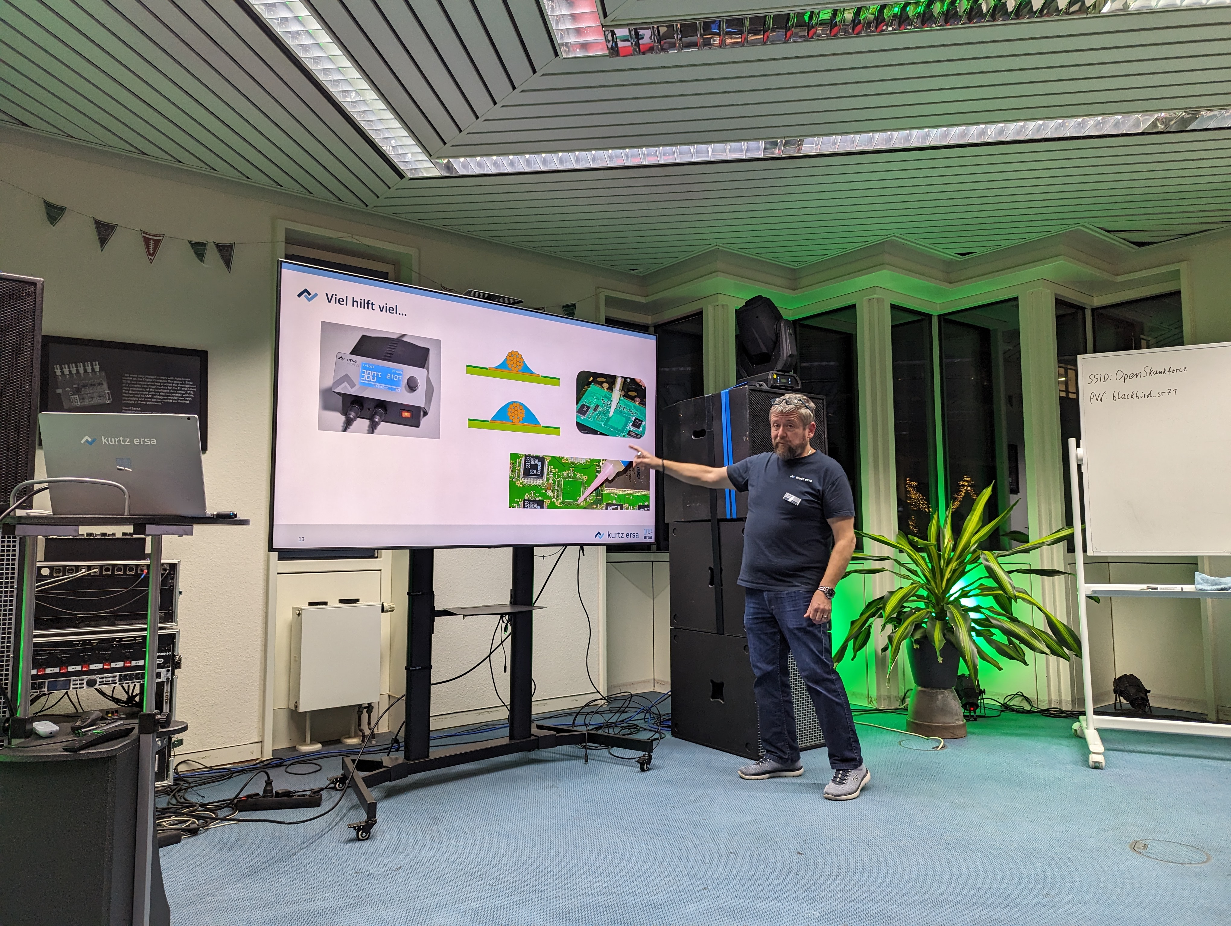 A smaller OSF evening event — focused format, green lighting, engaged audience